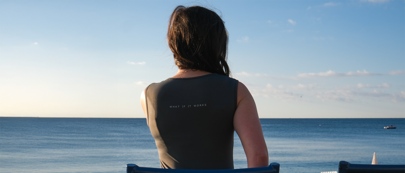 Back view of a woman wearing a Theia Moon tank top with a discreet positive affirmation embroidered on the back